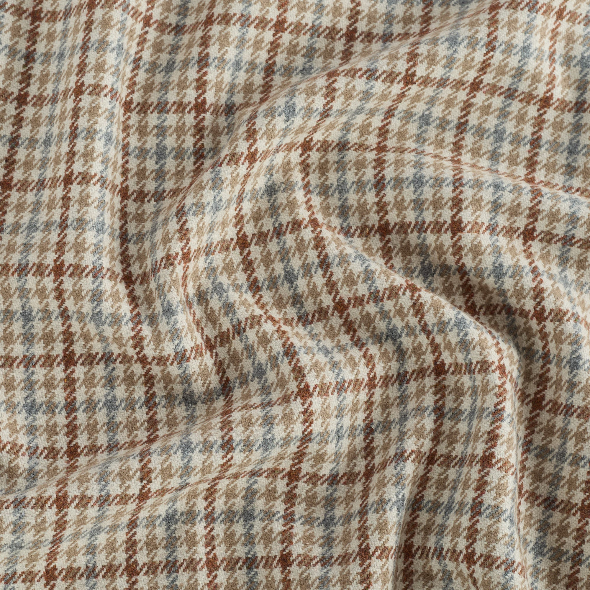 Vesper Paprika plaid home decor fabric with a beige, chambray blue, and cinnamon palette.