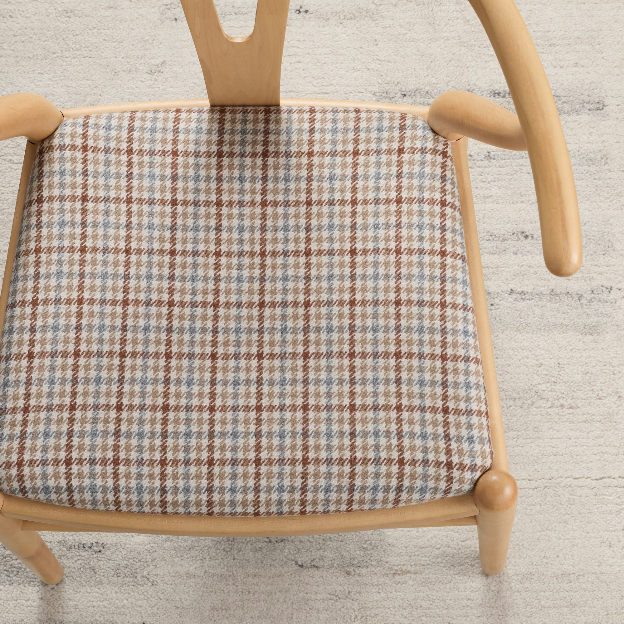 Vesper Paprika houndstooth fabric shown upholstered on a dining chair seat by Tonic Living.