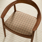 Tonic Living Walker Plaid Camel upholstery fabric shown on a chair seat with a tailored windowpane check pattern.