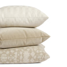 Stack of Tonic Living neutral pillows featuring checkerboard, textured, and velvet designs.