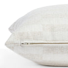 a greige and cream checkerboard patterned throw pillow : zipper detail