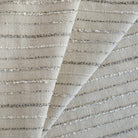 a neutral beige and grey textured striped upholstery fabric