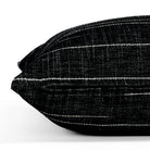 Yuzu Onyx, a black and white pillow from Tonic Living, showcasing a dappled texture accented with organic white lines: close-up zipper view.