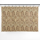 One yard of Tonic Living Zuri Driftwood multi-use fabric hanging from clips, showing the full ornamental medallion pattern.
