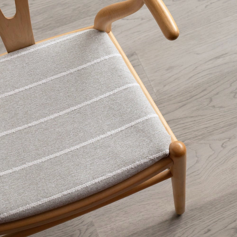 Grey striped Avalon Putt high performance upholstery fabric on a wishbone chair