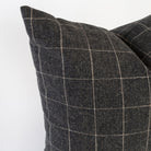 Dundee Sable, a charcoal grey and natural windowpane pillow : close up corner view