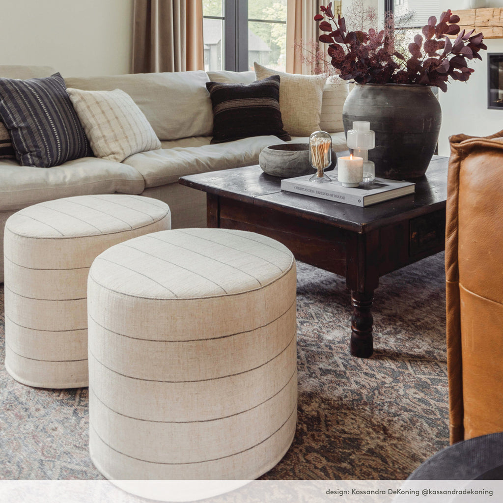 modern farmhouse living room with tonic living round striped ottoman. Designed by Kassandra DeKoning.