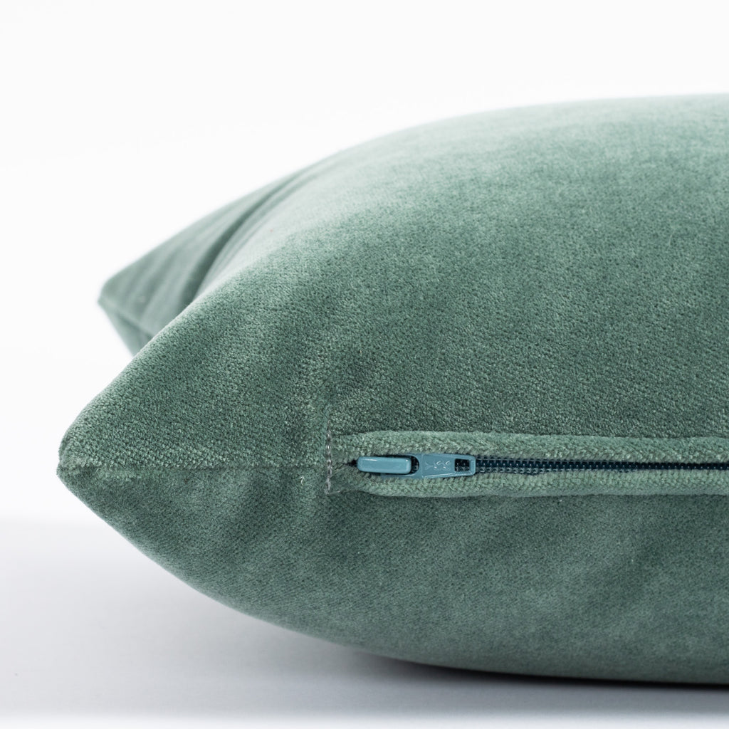 A jade green velvet lumbar throw pillow : zip detail