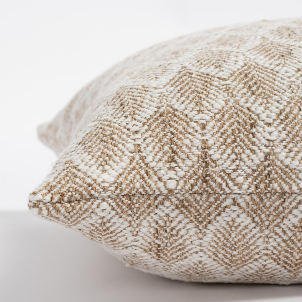 a creamy white and light brown nubbly wheat sheaf patterned decorative pillow : close up photo