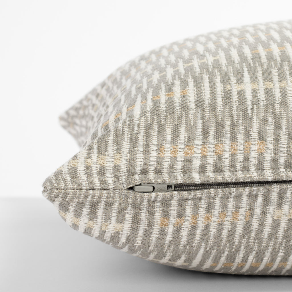 a grey, beige and cream graphic abstract pattern throw pillow : side zipper detail