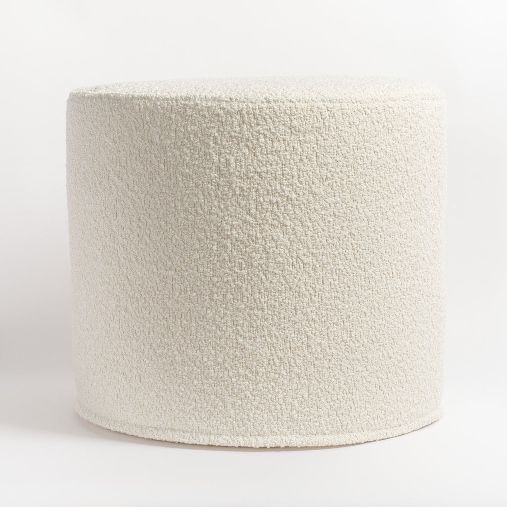 Cambie Boucle Chalk Ottoman, a creamy, off-white boucle fabric round ottoman : side