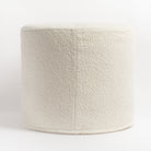 Cambie Boucle Chalk Ottoman, a creamy, off-white boucle fabric round ottoman : side with seam