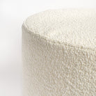 Cambie Boucle Chalk Ottoman, a creamy, off-white boucle fabric round ottoman : close up top