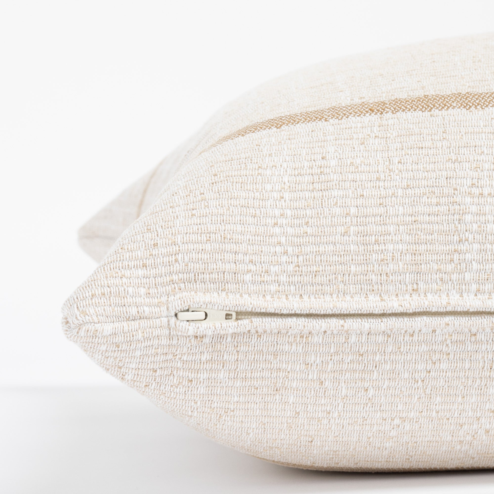  a caramel and cream stripe throw pillow : zipper detail