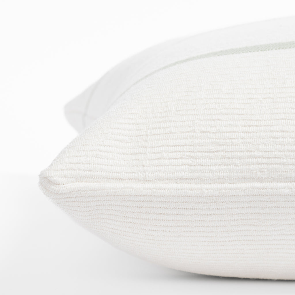 a white and green stripe throw pillow : close up side view