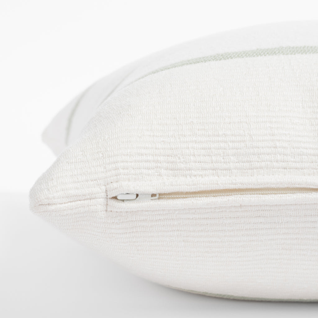 a white and green stripe throw pillow : close up zipper view