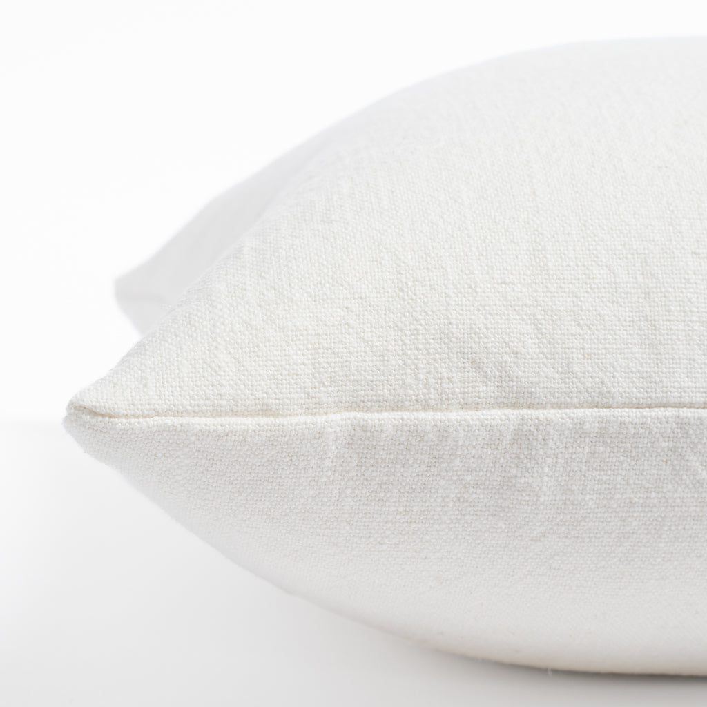 a cream white pillow: close up side view 