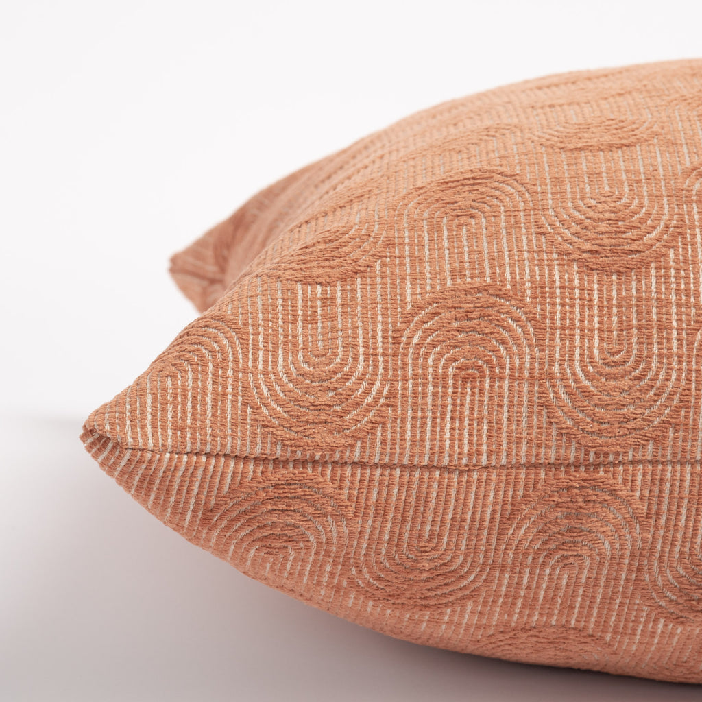 Cordoba Arch 20x20 Pillow Terracotta, a clay pink pillow with a flowing arch pattern : close up side view
