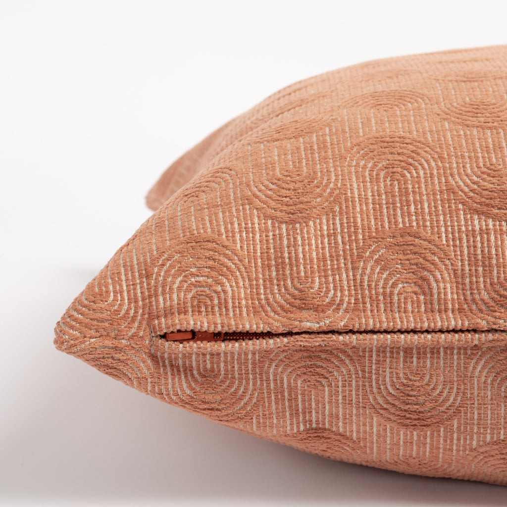Cordoba Arch 20x20 Pillow Terracotta, a clay pink pillow with a flowing arch pattern : close up zipper side