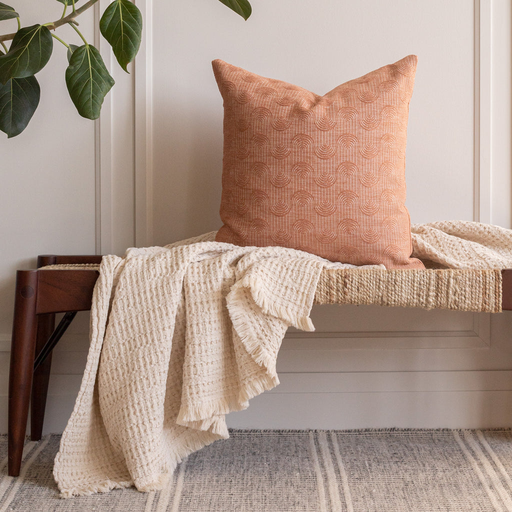 pink clay toned pillow and cream throw from Tonic Living