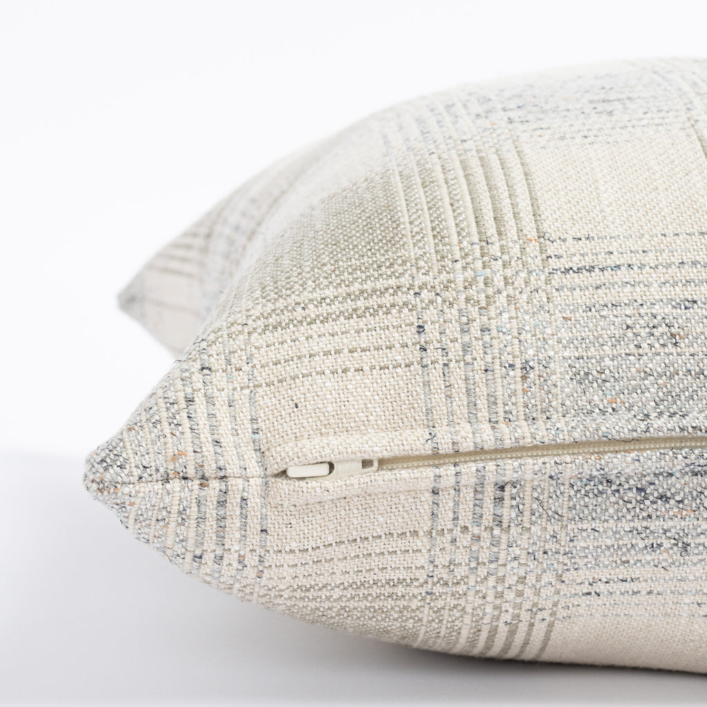 a light grey and denim blue plaid throw pillow : close up zipper view