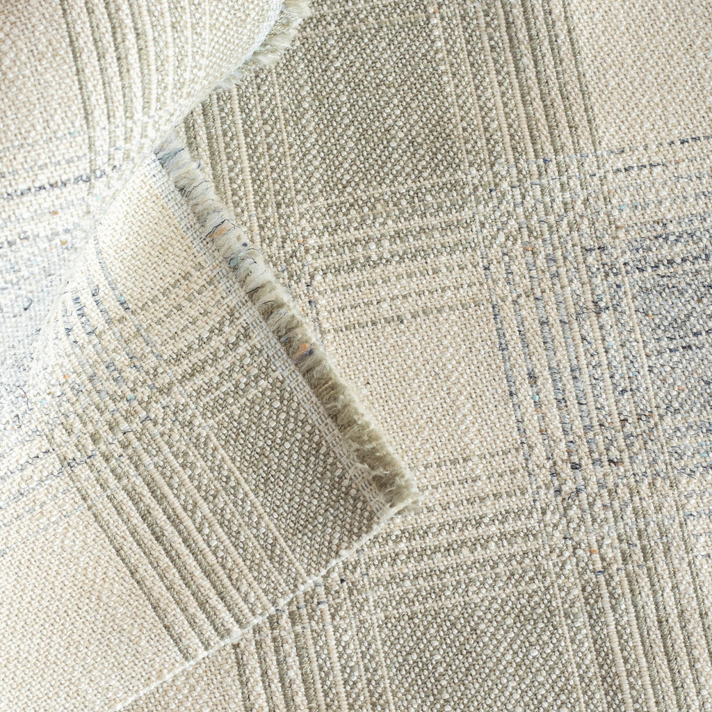 a light grey and denim blue upholstery fabric: close up view