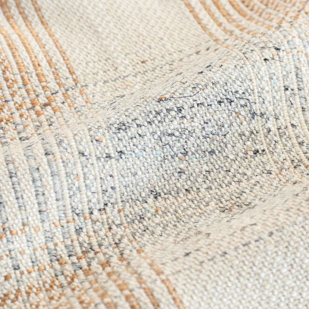 a cream, terracotta and blue plaid upholstery fabric : close up view 2