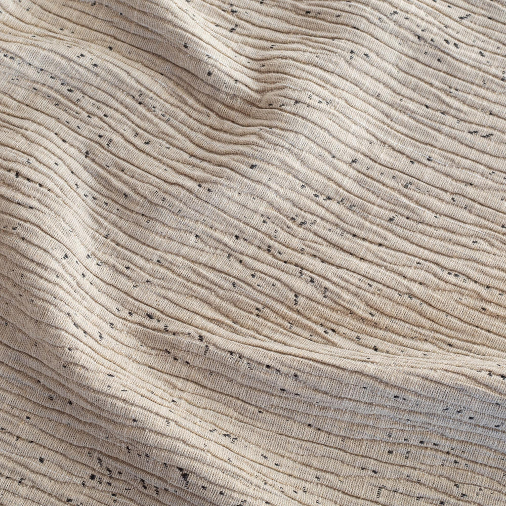 Dunes Natural, a textured beige upholstery fabric with flecks of grey from Tonic Living