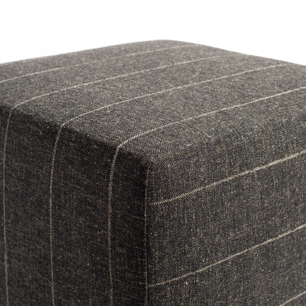 a charcoal grey and tan stripe cube ottoman : corner detail shot