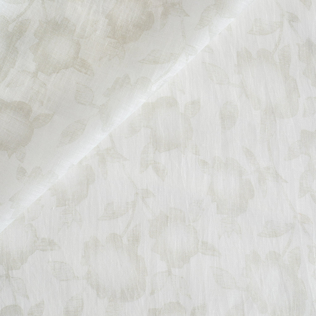 a soft white and beige floral print sheer fabric