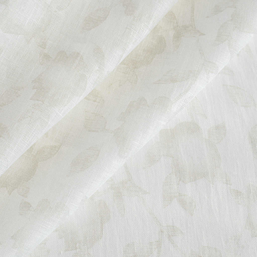 a cream white and beige floral print sheer fabric