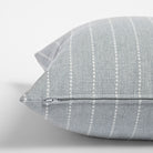 Fontana Cloud 20x20 pillow, a pale blue grey and white vertical stripe indoor outdoor pillow : close up zipper view