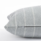 a blue grey and white stripe lumbar pillow : zipper detail