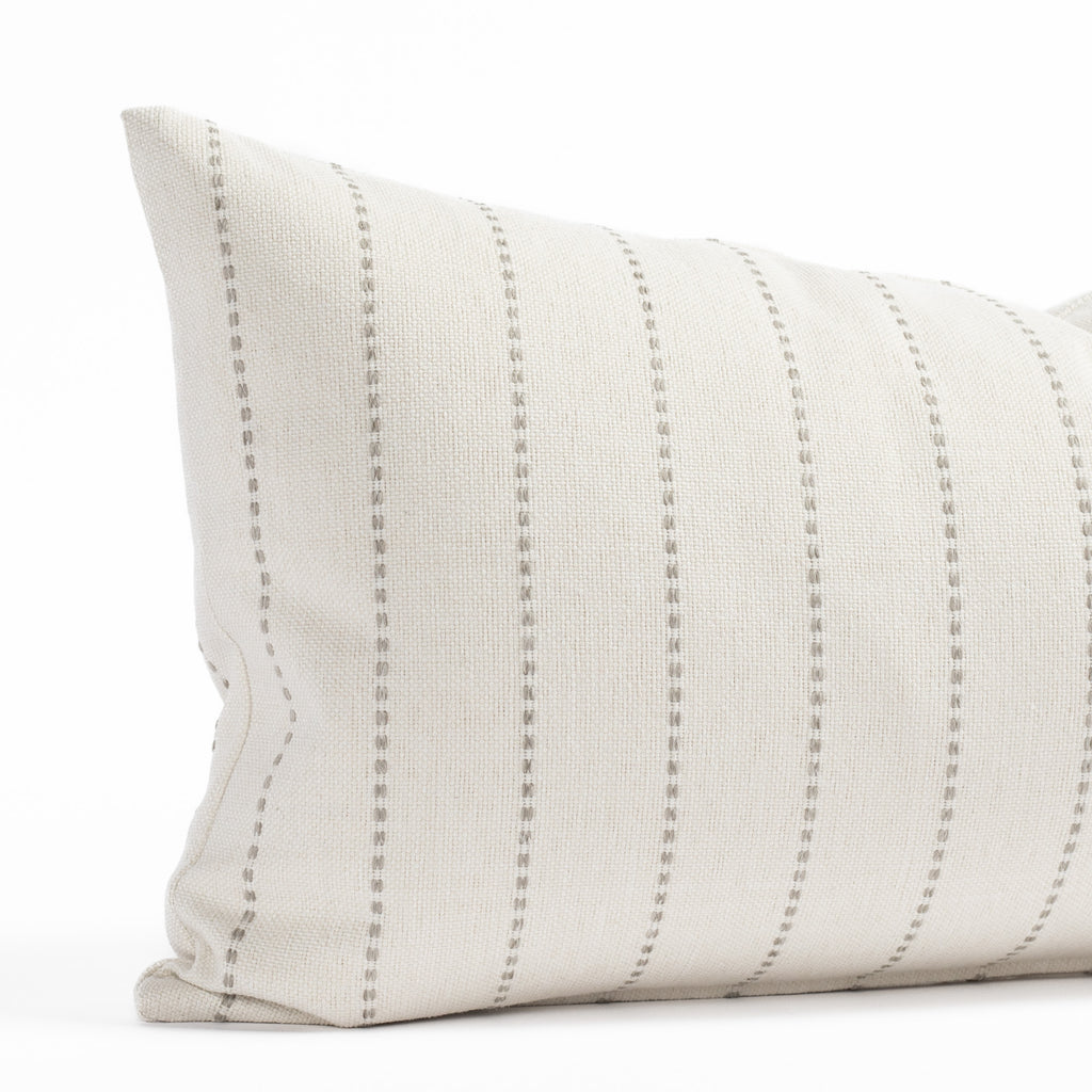 a cream and grey vertical striped indoor outdoor lumbar throw pillow 