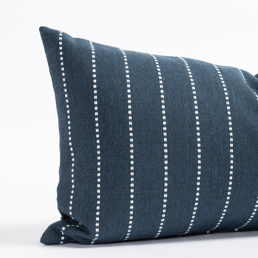 a navy blue and white stripe lumbar pillow 