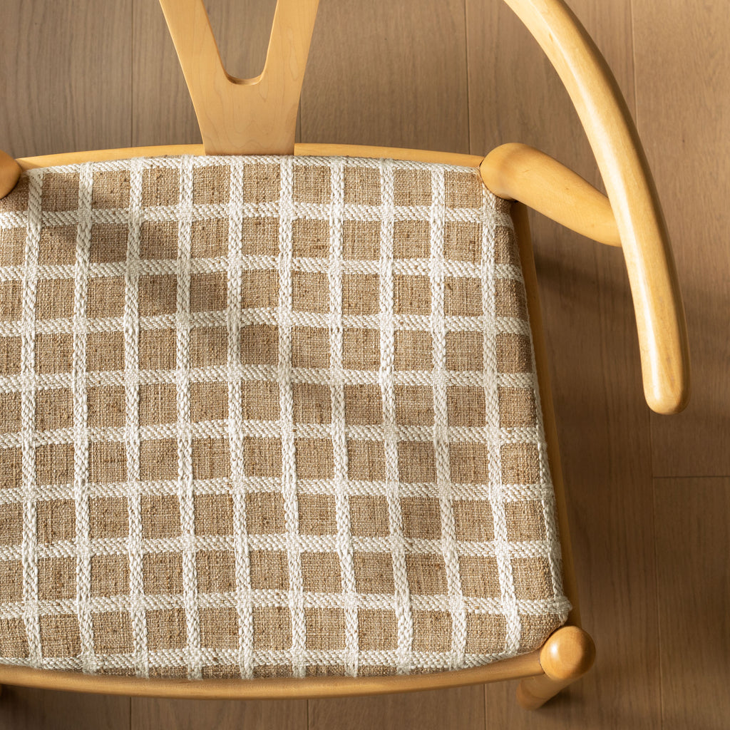 a light brown and cream windowpane check upholstered seat 