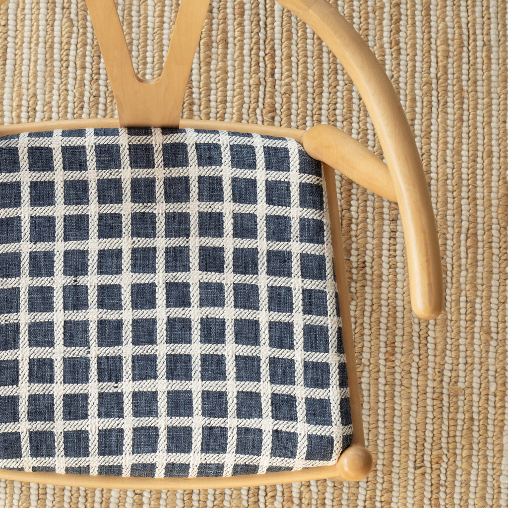 an navy blue and cream plaid check upholstered chair seat 