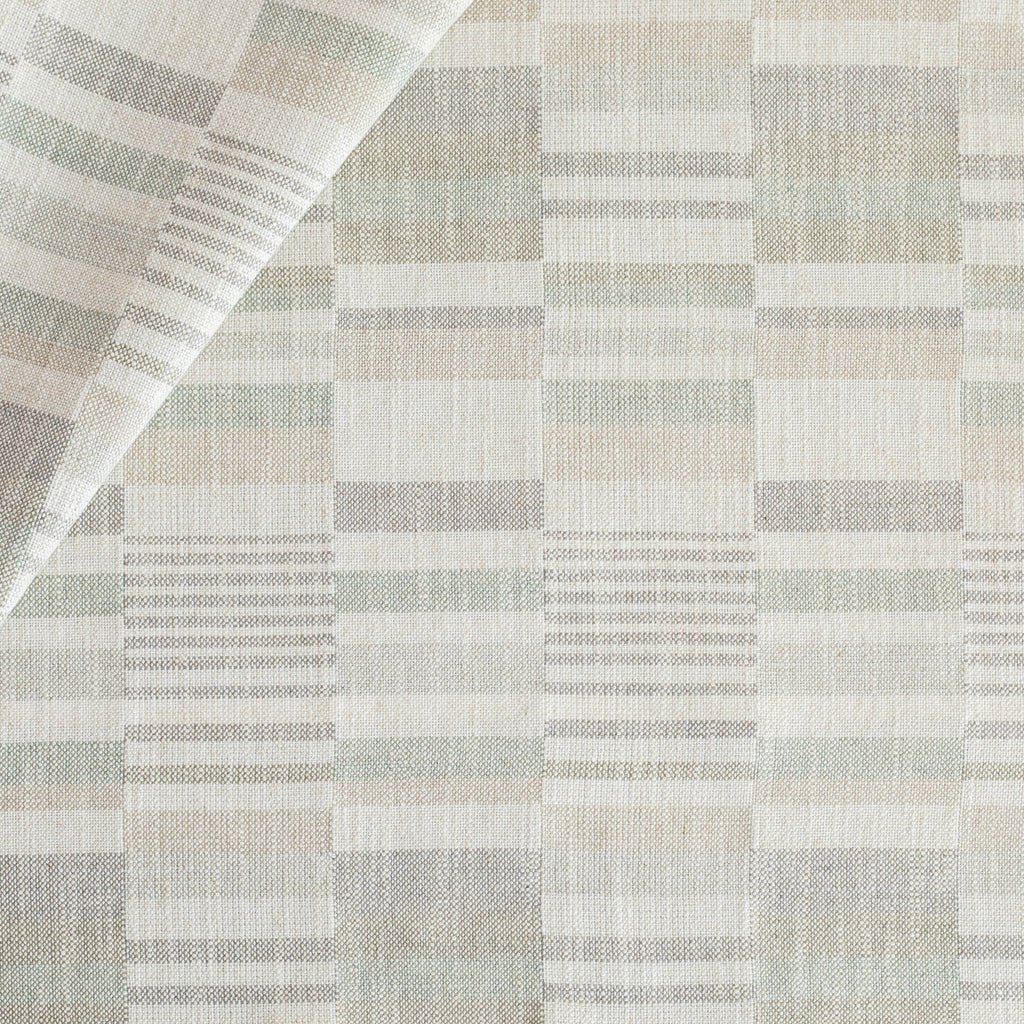 a geometric patchwork patterned upholstery fabric in costal watery blue, green, grey colours from Tonic Living