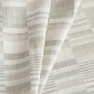 a geometric patchwork patterned home decor fabric in costal watery green, sand, and grey colours
