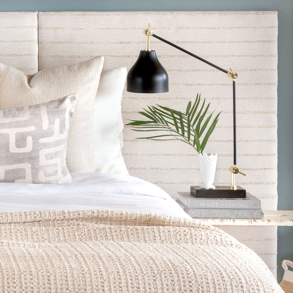 Neutral bed vignette: Handlavet Stripe raffia fabric headboard with Karru silver bed bolster and Milly cream pillows and Lena throw blanket