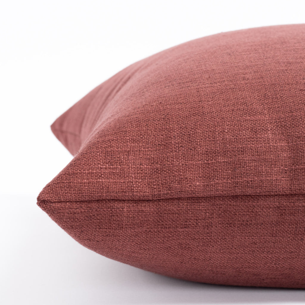 a pinky red throw pillow : side view