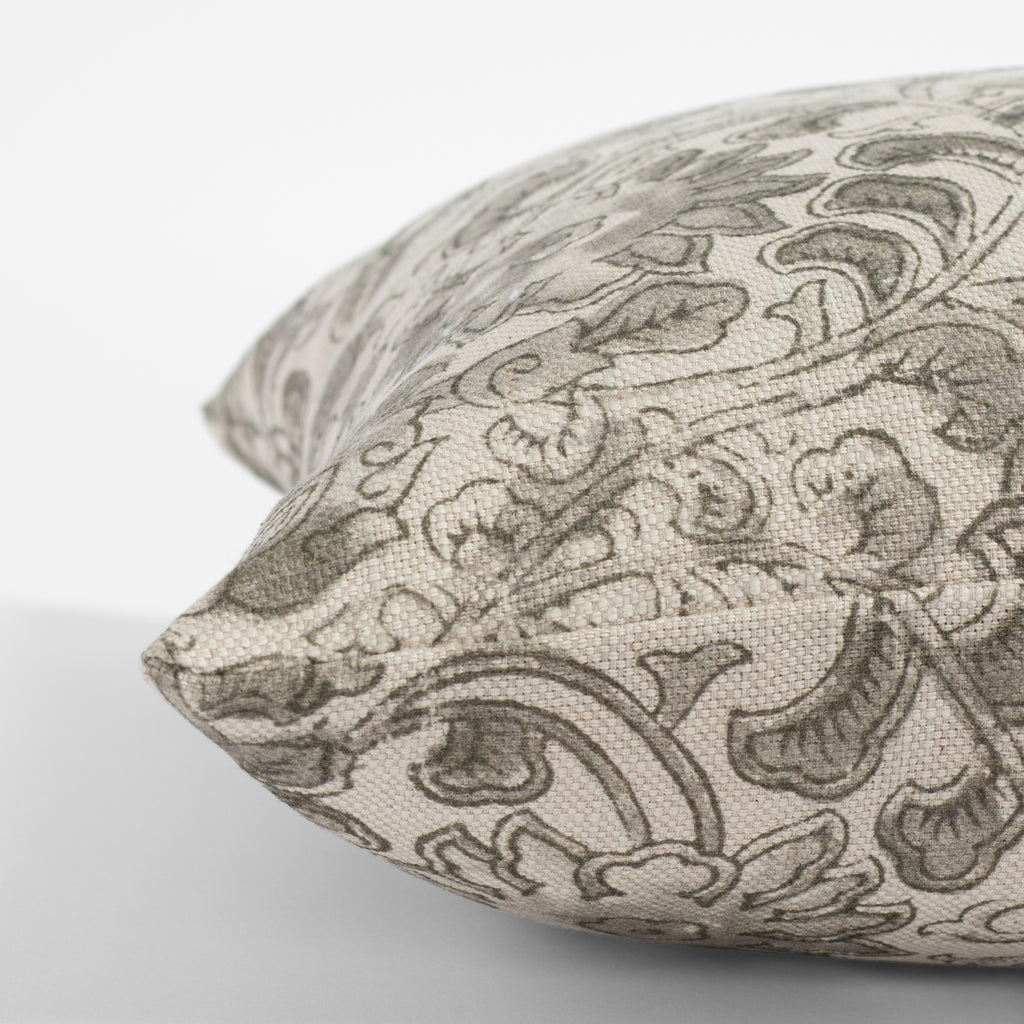a grey swirling floral vine print throw pillow : side view