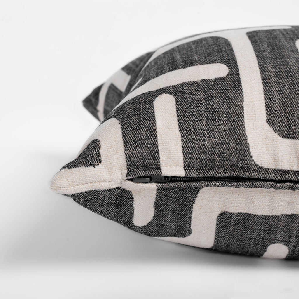 dark grey and beige abstract print lumbar throw pillow zipper detail
