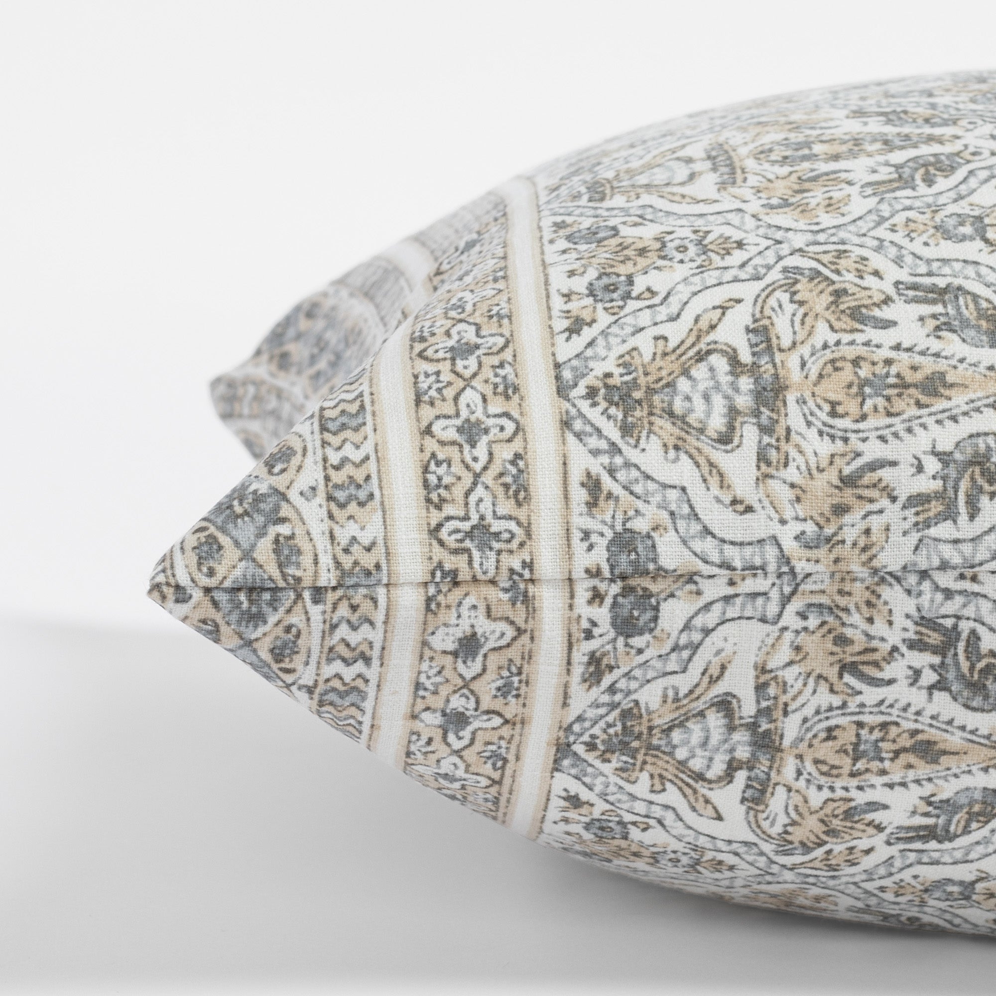 a tan and light blue-grey motif intricate block print throw pillow : side view