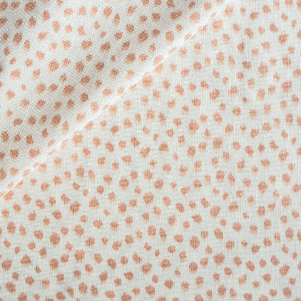 a white and pink inky polka dot print tonic living fabric
