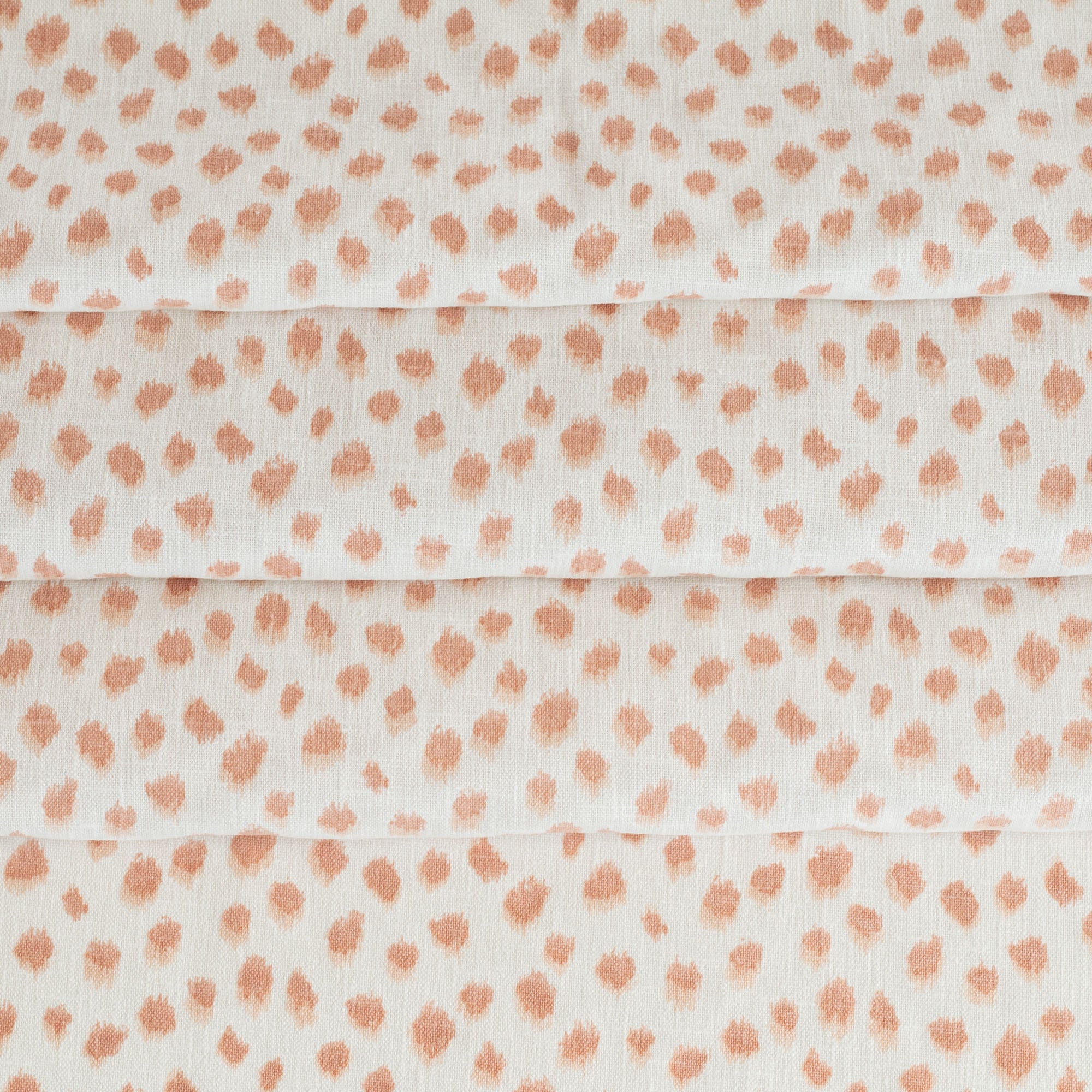 a white and pink inky polka dot print home decor fabric