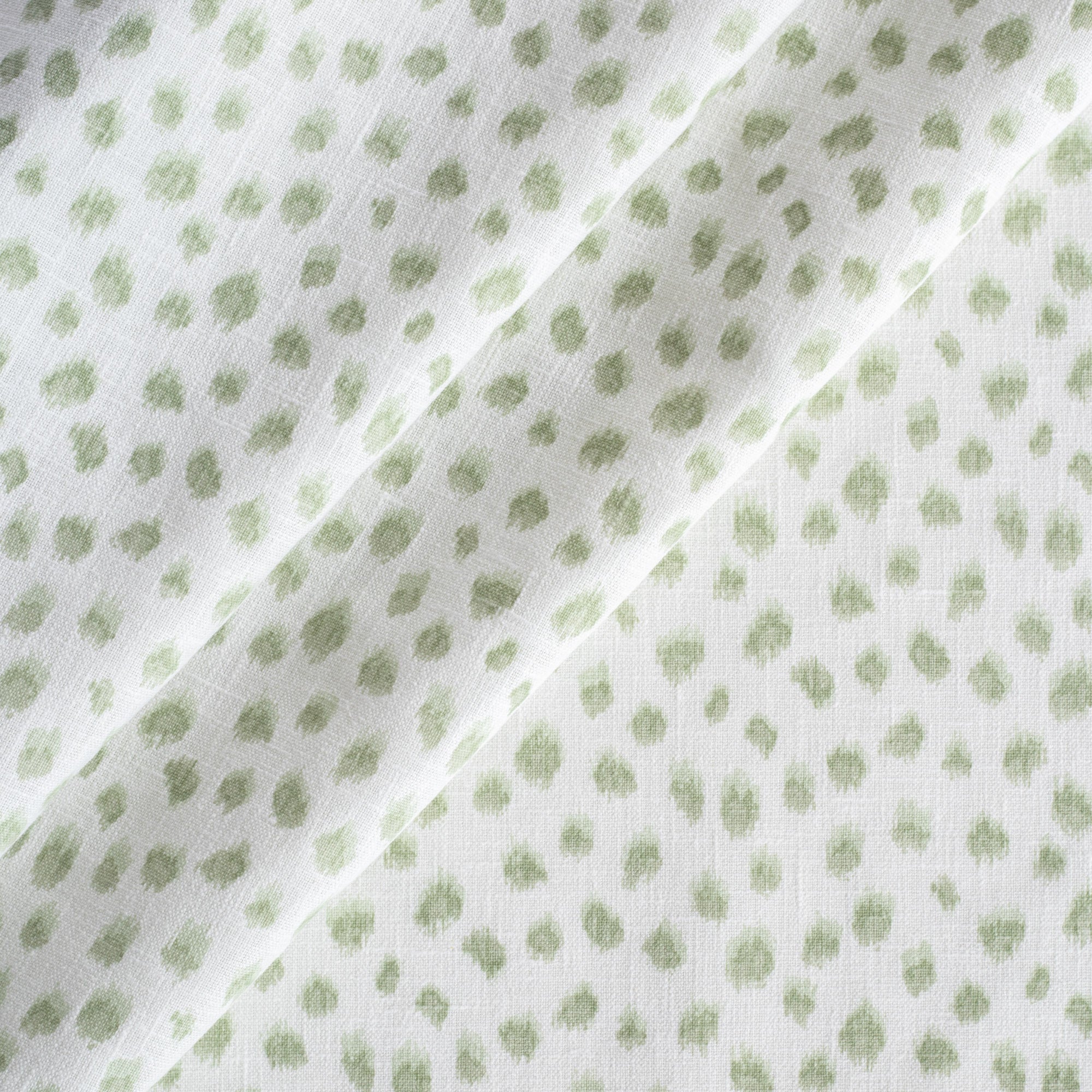 a white and green inky dot print fabric