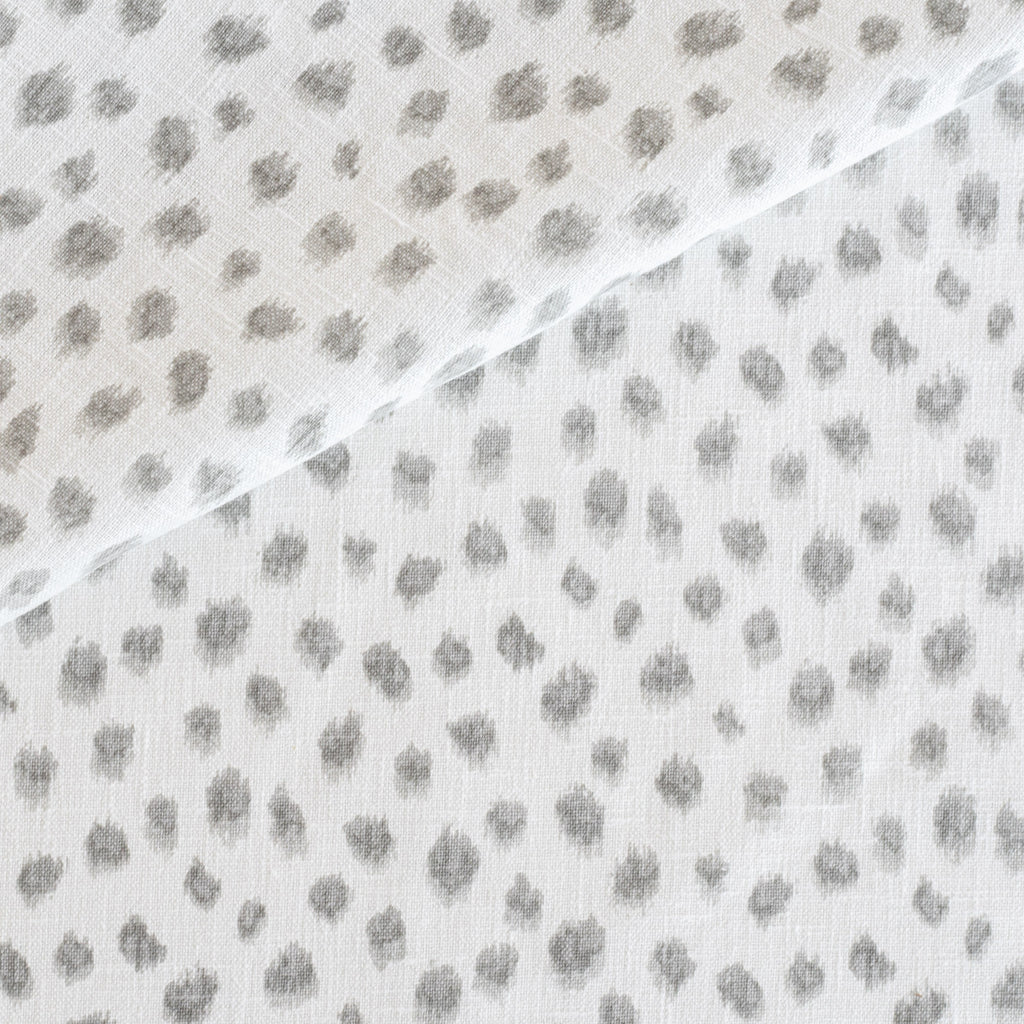 a white and silver grey inky polka dot print home decor fabric