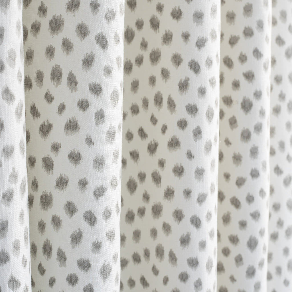 Mara Spot, a white and soft grey dot print curtain fabric