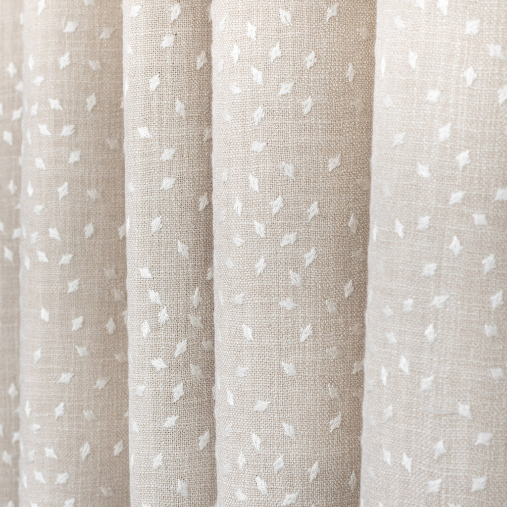 Masie Pearl, a sandy beige home decor fabric with a scattering of embroidered ivory flecks from Tonic Living